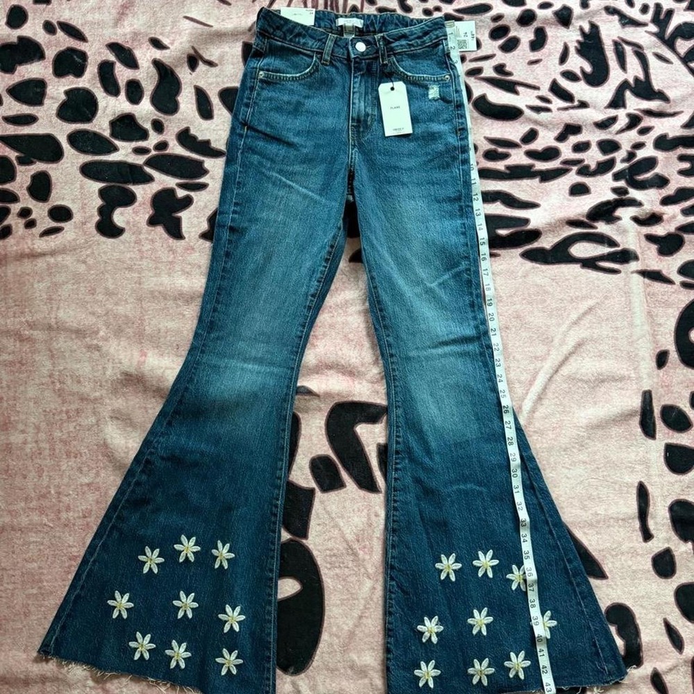 Forever 21 Flare jeans with white floral embroidery on the lower legs
